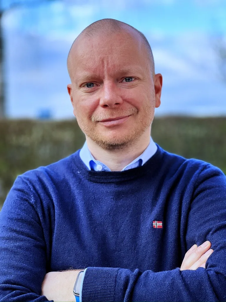 René Fischer wearing a blue sweater outdoors.