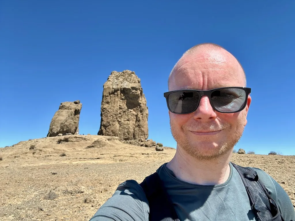 René Fischer at Roque Nublo on Gran Canaria under a clear blue sky.